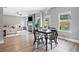 Open living space with dining area, fireplace, and large windows at 31 Village Trce, Rydal, GA 30171
