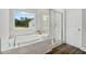 Gorgeous bathroom with a soaking tub, separate shower, and a view of the backyard at 31 Village Trce, Rydal, GA 30171