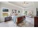 Spacious main bedroom with tray ceiling, large windows, and neutral decor at 31 Village Trce, Rydal, GA 30171
