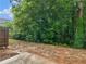Backyard with mature trees and an unfinished patio at 3135 Journal Ct, Decatur, GA 30035