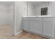Bright bathroom with white cabinets, laminate floors and view of the walk-in closet at 3135 Journal Ct, Decatur, GA 30035