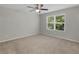 Neutral bedroom featuring plush carpeting, a ceiling fan, and a window with natural light at 3135 Journal Ct, Decatur, GA 30035
