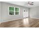 Bright bedroom with wood-look floors, large windows, and access to the outside at 3135 Journal Ct, Decatur, GA 30035