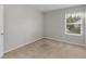 Neutral-colored bedroom with a bright window and plush carpet at 3135 Journal Ct, Decatur, GA 30035