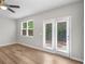 Inviting bedroom features wood-look flooring, neutral walls, large windows, and access to the outside providing a cozy retreat at 3135 Journal Ct, Decatur, GA 30035