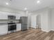 Well-equipped kitchen with stainless steel appliances, granite countertops, and white cabinetry in a modern townhome at 3135 Journal Ct, Decatur, GA 30035