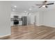 Open-concept living area features wood-look flooring, ample natural light, and a modern kitchen for easy entertaining at 3135 Journal Ct, Decatur, GA 30035