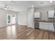 Open-concept living area features wood-look flooring, ample natural light, and access to the kitchen area at 3135 Journal Ct, Decatur, GA 30035