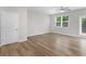Bright living area featuring wood-look flooring, large windows, and neutral paint providing a blank canvas at 3135 Journal Ct, Decatur, GA 30035