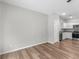 Bright living area featuring wood-look floors that lead to the modern kitchen with stainless steel appliances at 3135 Journal Ct, Decatur, GA 30035