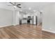 Open floor plan with wood-look floors and a modern kitchen with stainless steel appliances and white cabinets at 3135 Journal Ct, Decatur, GA 30035