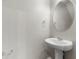 Clean powder room with a pedestal sink and oval mirror at 3135 Journal Ct, Decatur, GA 30035