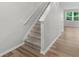 Bright entryway featuring a carpeted staircase, light gray walls, and wood-look flooring leading to the main living area at 3135 Journal Ct, Decatur, GA 30035