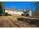 View of the spacious backyard featuring a lush lawn, a screened-in porch, and a stairway to the second level at 6865 Cowan Mill Rd, Winston, GA 30187