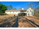 Expansive backyard with a spacious lawn, a screened-in porch, and a stairway to the second level at 6865 Cowan Mill Rd, Winston, GA 30187