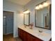 Bathroom featuring double sink vanity with elegant mirrors and fixtures at 6865 Cowan Mill Rd, Winston, GA 30187