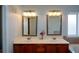 Bathroom featuring double sink vanity with elegant mirrors and fixtures at 6865 Cowan Mill Rd, Winston, GA 30187
