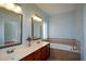 Elegant bathroom featuring double sinks, vanity, and separate tub at 6865 Cowan Mill Rd, Winston, GA 30187