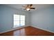 This room has lots of light, hardwood floors, and a ceiling fan at 6865 Cowan Mill Rd, Winston, GA 30187