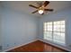 This light blue bedroom features a ceiling fan and a window with natural light at 6865 Cowan Mill Rd, Winston, GA 30187