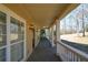 Covered front porch with painted wood railing and traditional-style siding and stained trim at 6865 Cowan Mill Rd, Winston, GA 30187