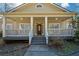 Charming home features a covered front porch with wood railing and traditional front door at 6865 Cowan Mill Rd, Winston, GA 30187