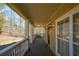 Covered front porch with painted wood railing and traditional-style siding and stained trim at 6865 Cowan Mill Rd, Winston, GA 30187