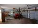 Spacious garage with multiple doors, cabinets, and plenty of room for storage and equipment, like the featured tractor at 6865 Cowan Mill Rd, Winston, GA 30187