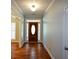 Inviting hallway with hardwood floors leads to an oval door with sidelights at 6865 Cowan Mill Rd, Winston, GA 30187