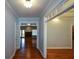 Welcoming hallway with hardwood floors and decorative molding throughout the home at 6865 Cowan Mill Rd, Winston, GA 30187