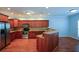 Well-lit kitchen featuring stainless steel appliances, wood cabinets, breakfast bar, and hardwood flooring at 6865 Cowan Mill Rd, Winston, GA 30187