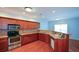 Bright kitchen with wooden cabinets, stainless steel appliances, and wood flooring at 6865 Cowan Mill Rd, Winston, GA 30187