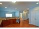 Bright open concept kitchen with wood floors and ample cabinet storage at 6865 Cowan Mill Rd, Winston, GA 30187