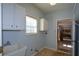 Functional laundry room with a utility sink, white cabinets, and a window for natural light at 6865 Cowan Mill Rd, Winston, GA 30187