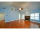 Bright, open living room with hardwood floors, a fireplace, high ceilings, and natural light at 6865 Cowan Mill Rd, Winston, GA 30187