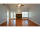 Bright living room with hardwood floors, vaulted ceilings, fireplace, and French doors at 6865 Cowan Mill Rd, Winston, GA 30187