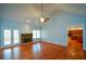 Living room featuring hardwood floors, a stone fireplace, and a view into the kitchen at 6865 Cowan Mill Rd, Winston, GA 30187