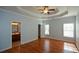 Spacious main bedroom featuring a tray ceiling, hardwood floors, and ensuite bath at 6865 Cowan Mill Rd, Winston, GA 30187