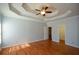 Hardwood floors and bright windows in spacious main bedroom with tray ceiling at 6865 Cowan Mill Rd, Winston, GA 30187