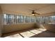 Bright sunroom with views of wooded lot, ceiling fan, wood flooring and lots of windows at 6865 Cowan Mill Rd, Winston, GA 30187