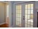 Bright sunroom with natural light streams in through glass paneled double doors at 6865 Cowan Mill Rd, Winston, GA 30187