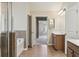 Primary bathroom view with tub, vanities and tile floor plus an open doorway leading to the main bedroom at 2638 Lake Manor Cir, Duluth, GA 30096