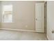 This bedroom features neutral walls, carpet, and a window providing natural light, offering a blank canvas at 2638 Lake Manor Cir, Duluth, GA 30096