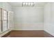 Formal dining room with classic wainscoting, plantation shutters, and hardwood floors at 2638 Lake Manor Cir, Duluth, GA 30096