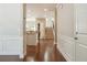 Bright entryway with hardwood floors, white wainscoting, and open view to kitchen and staircase at 2638 Lake Manor Cir, Duluth, GA 30096