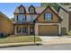 Charming two-story home featuring a brick facade, dormer windows, and a well-maintained lawn at 2638 Lake Manor Cir, Duluth, GA 30096