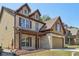 Side view of a beautiful two-story house with a brick and vinyl siding exterior and an attached garage at 2638 Lake Manor Cir, Duluth, GA 30096