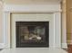 Close-up of a fireplace with hexagon tile surround and white mantel, adding a cozy focal point at 2638 Lake Manor Cir, Duluth, GA 30096