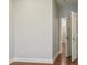 Bright hallway with hardwood floors, neutral paint and door access to bedrooms and/or bathrooms at 2638 Lake Manor Cir, Duluth, GA 30096