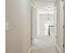 Hallway showing neutral walls and carpet, doors leading to rooms, and natural light from a distant window at 2638 Lake Manor Cir, Duluth, GA 30096